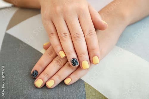 Female hands with stylish manicure on fabric  closeup