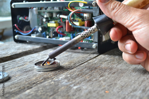 Repair of equipment with a soldering iron.