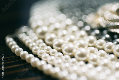 Pearl necklace close-up in the defocus on a dark background