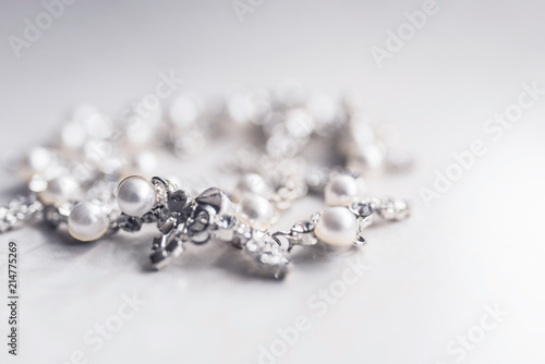 Pearl silver necklace on a white background close-up in the defocus