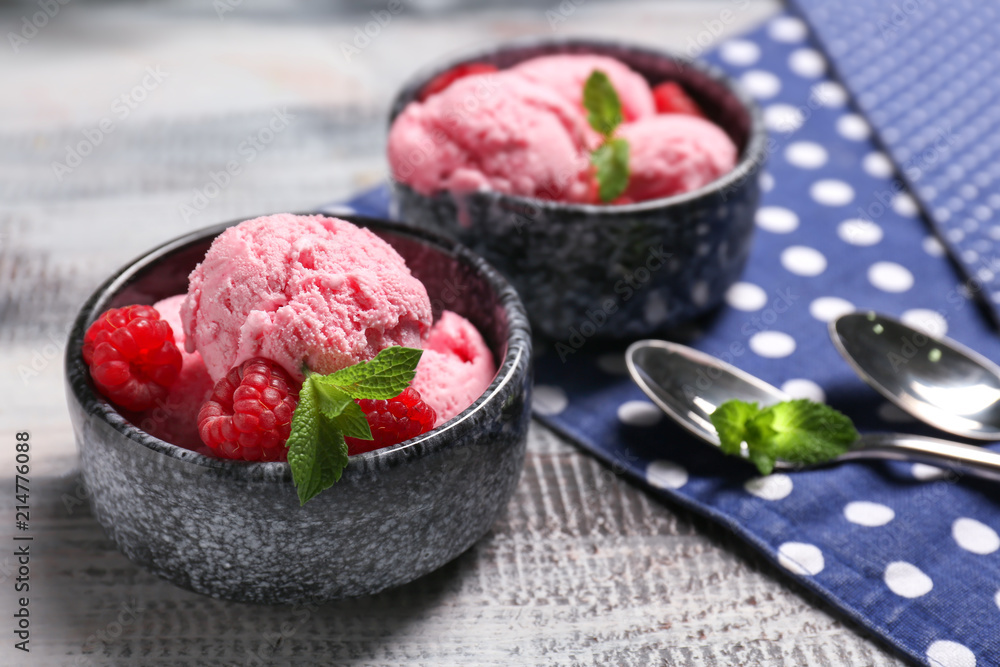 Bowls with delicious raspberry ice-cream on wooden table Bowls with delicious raspberry ice-cream on wooden table