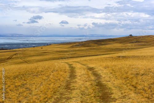 Track winding back roads in the mountains. Dirt road on Olkhon island in lake Baikal. photo