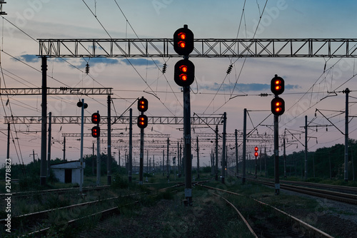 railroad traffic lights and infrastructure during beautiful sunset, colorful sky, transportation and industrial concept