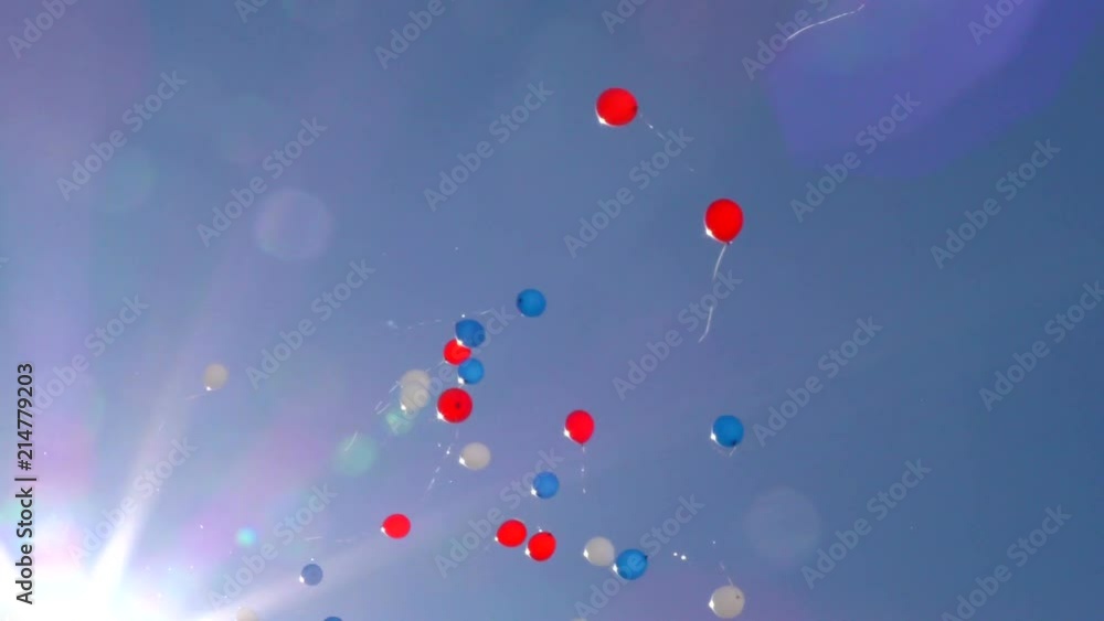Balloons in the heavenly rays of the sun. Flying festive balloons in the blue sky. Balloons in the heavenly rays of the sun. Flying festive balloons in the blue sky.