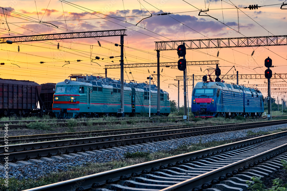 trains and wagons, railroad infrastructure, beautiful sunset and colorful sky, transportation and industrial concept