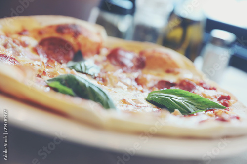 pepperoni bacon and ham pizza in restaurant background