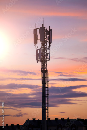 silhouette of telecommunications tower on sky background