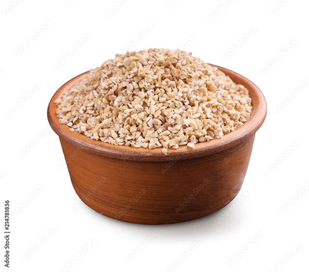Barley grits in wooden bowl isolated on white Barley grits in wooden bowl isolated on white