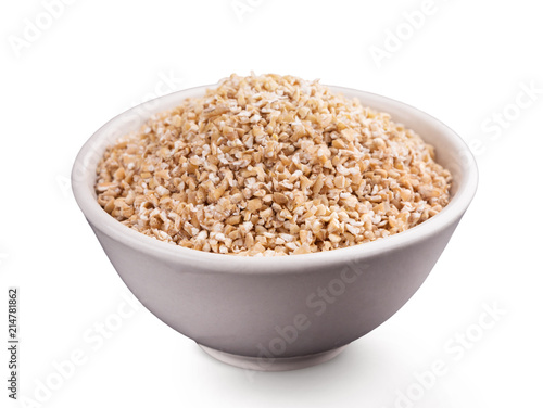 Barley grits in bowl isolated on white