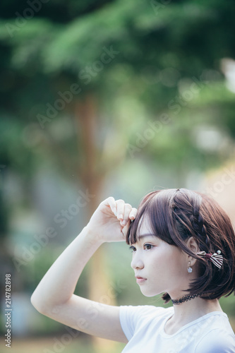 portrait of asian girl with white shirt and skirt looking in outdoor nature vintage film style