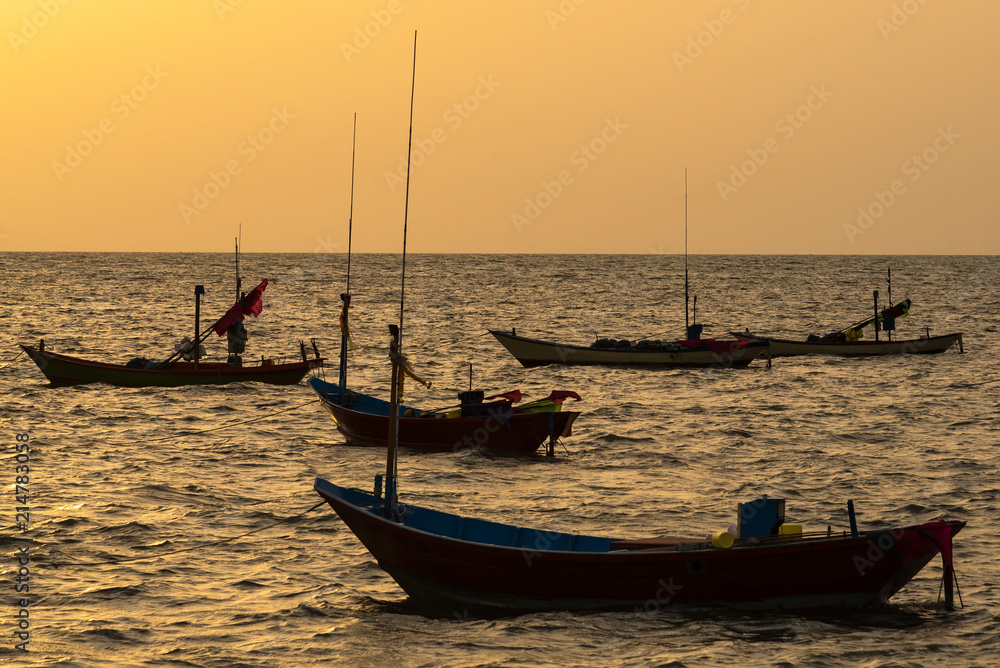 Floating fishing boats aground at the harbor in the sea sunset time at Chanthaburi, Thailand.