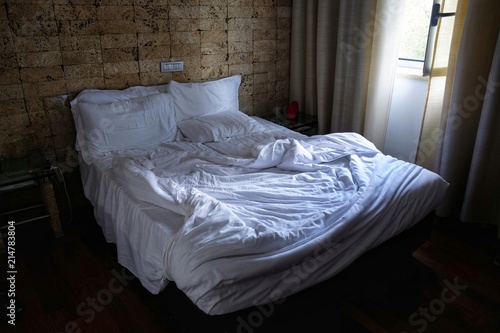 empty bed and unmade at the first light of dawn