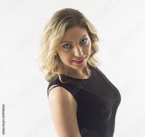 Beautiful, blonde hair young woman with white teeth and black dress isolated on white background