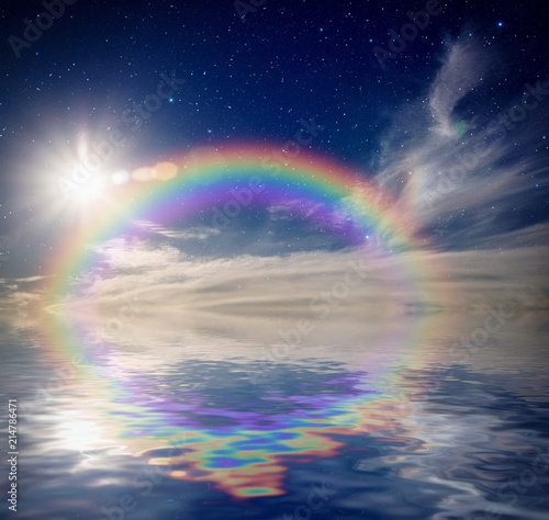 Colorful rainbow in clouds with star and sun reflecting in water.