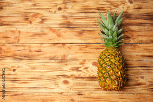 Delicious pineapple on wooden background