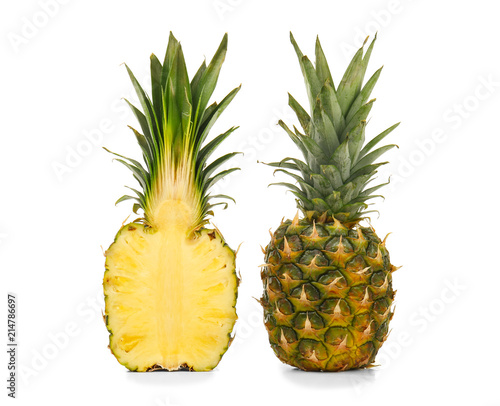 Cut and whole ripe pineapples and whole fruit on white background