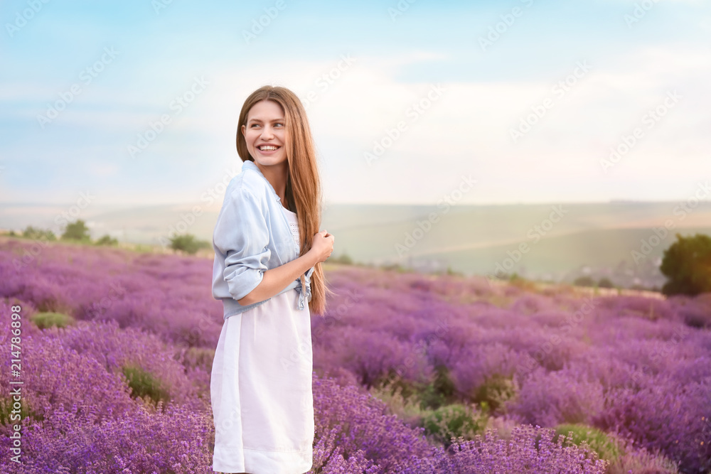 Beautiful young woman in lavender field on summer day Beautiful young woman in lavender field on summer day