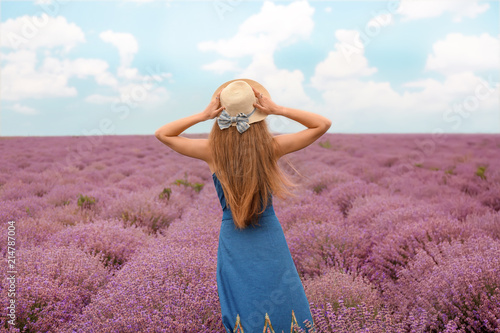 Fototapeta Naklejka Na Ścianę i Meble -  Beautiful young woman in lavender field on summer day
