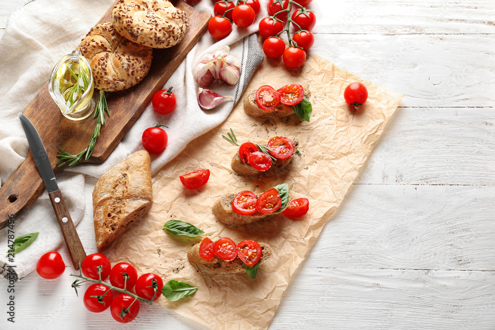 Composition with tasty sandwiches and fresh ripe cherry tomatoes on table