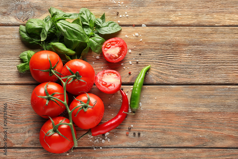 Fresh ripe cherry tomatoes, basil and chili pepper on wooden background Fresh ripe cherry tomatoes, basil and chili pepper on wooden background