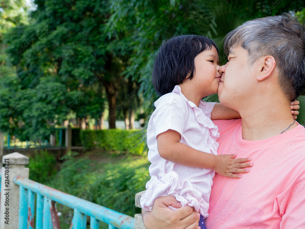 Fototapeta premium Daughter in the embrace of the father And kiss each other with love. Asia family and love concept