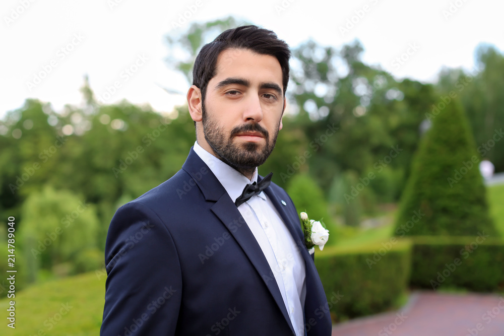 Handsome young groom in elegant suit outdoors Handsome young groom in elegant suit outdoors