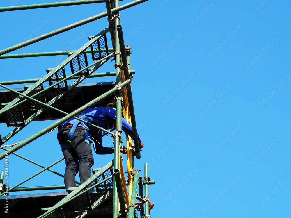 Fototapeta premium Construction workers working on scaffolding