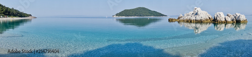 Sea rocks at calm and crystal clear turquoise water at morning, Milia beach, island of Skopelos, Greece