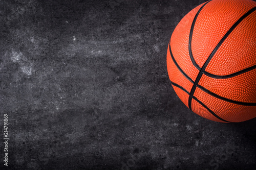 Basketball on black slate background. Copyspace.