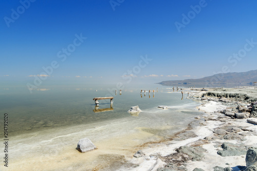 Wooden pillars with crystallized salt on Urmia Salt Lake. Iran photo