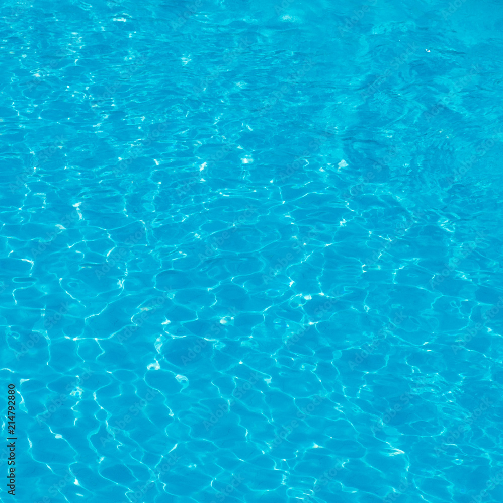 Background. Blue water with sunlight in the pool in the open air. view from above