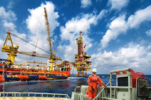Technician or worker on the crew boat during transfer to platform or drilling rig  in process oil and gas platform offshore,technician
