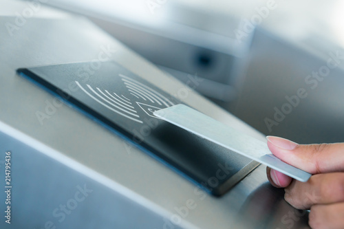Hand holding Blue Card to access Electronic Entrance Scanner photo