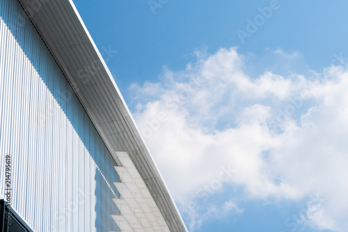 Factory Warehouse roof with cloudy blue sky
