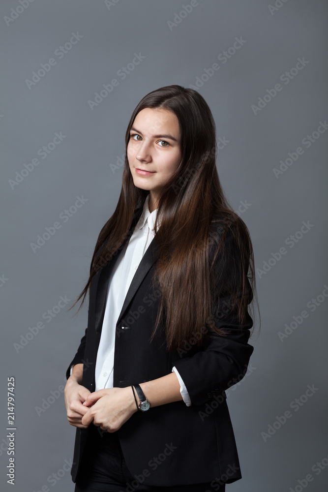 Portrait of happy nice schoolgirl teenager in white shirt on gray background Portrait of happy nice schoolgirl teenager in white shirt on gray background
