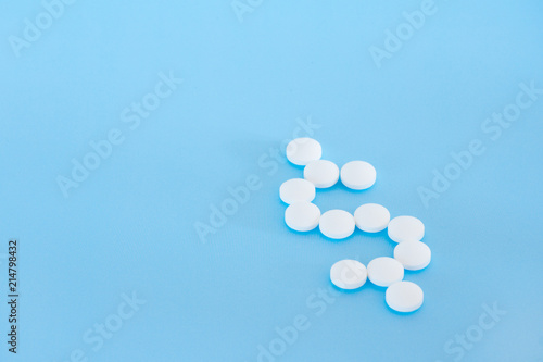 White pills on a blue background photo