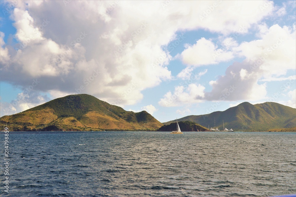 Boats on blue ocean with mountain landscape