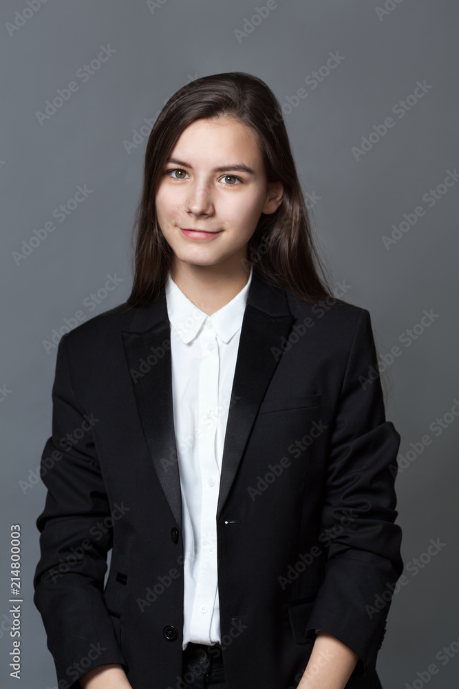 Portrait of happy nice schoolgirl teenager in white shirt on gray background Portrait of happy nice schoolgirl teenager in white shirt on gray background