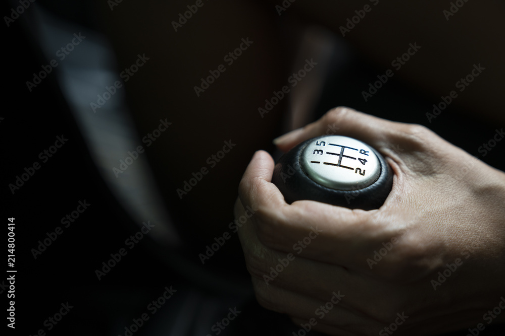 close up hand with manual gear shift lever, car transportation concept close up hand with manual gear shift lever, car transportation concept