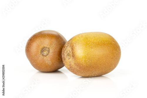 Group of two whole fresh golden brown kiwi fruit sungold variety isolated on white