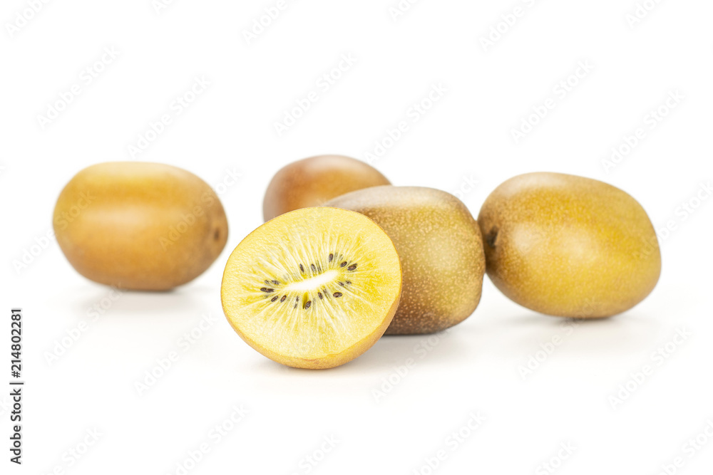 Fototapeta premium Group of five whole one half of fresh golden brown kiwi fruit sungold variety stack isolated on white