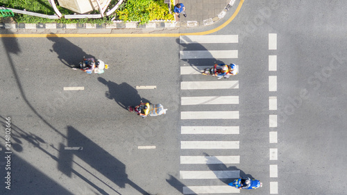 Photography Top view aerial photo of a driving motorcycle on asphalt track and pedestrian cr