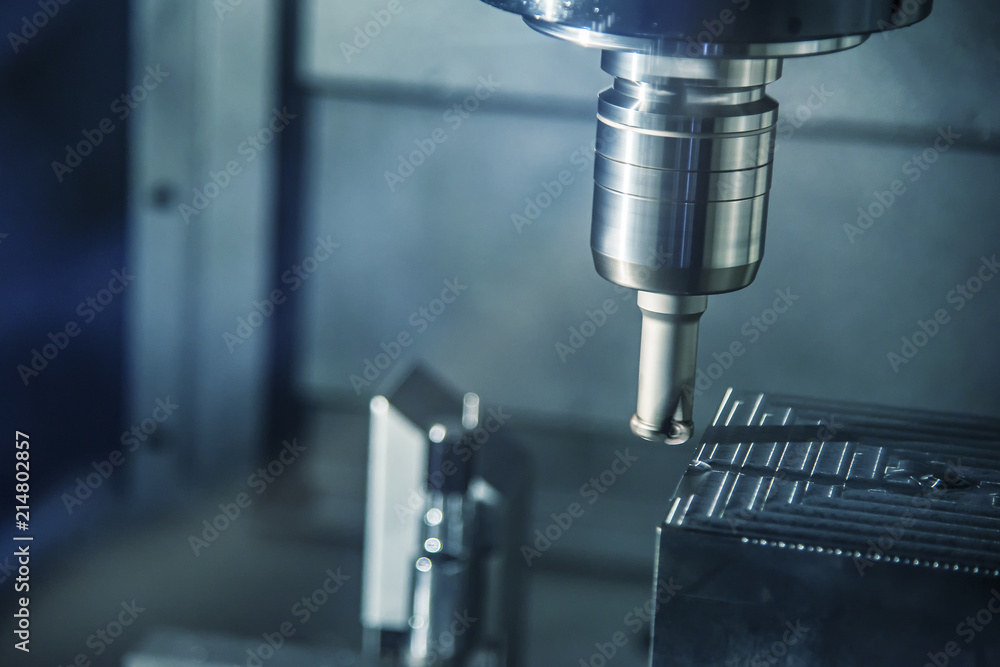 The CNC milling machine cutting the mold part in roughing process with the index-able radius end-mill tool.Hi-technology manufacturing process. The CNC milling machine cutting the mold part in roughing process with the index-able radius end-mill tool.Hi-technology manufacturing process.