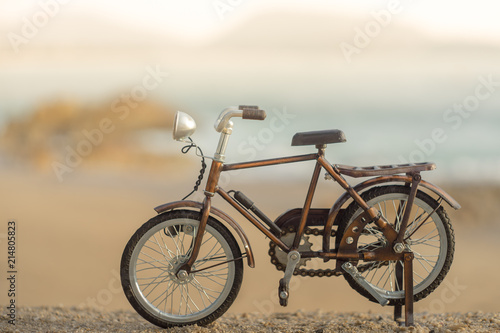 bicycle transport toy on sand sea beach in the evening sunset sky