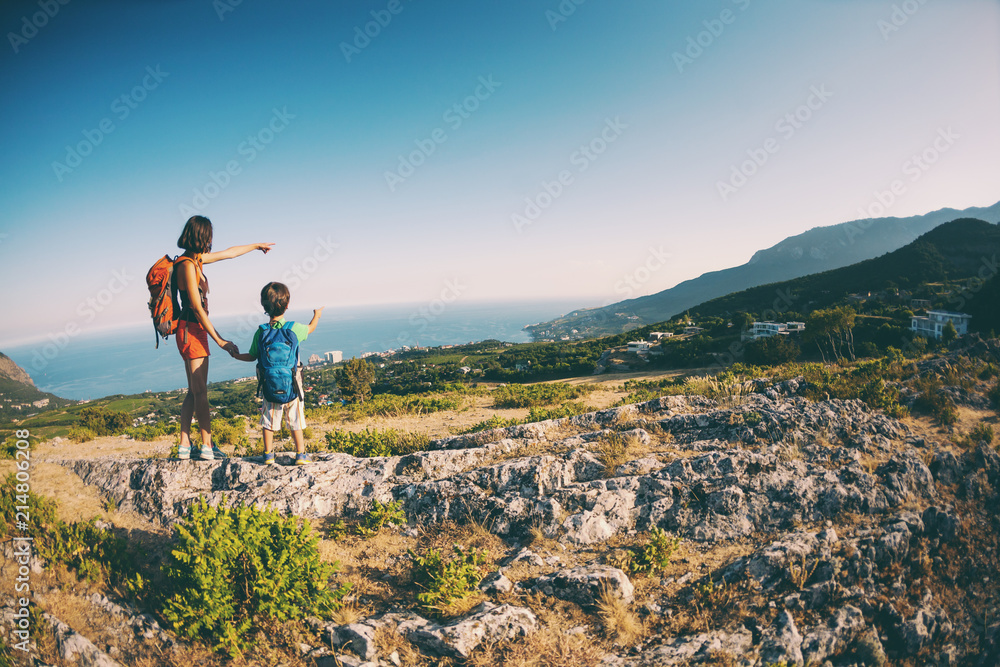 A woman is traveling with a child. A woman is traveling with a child.