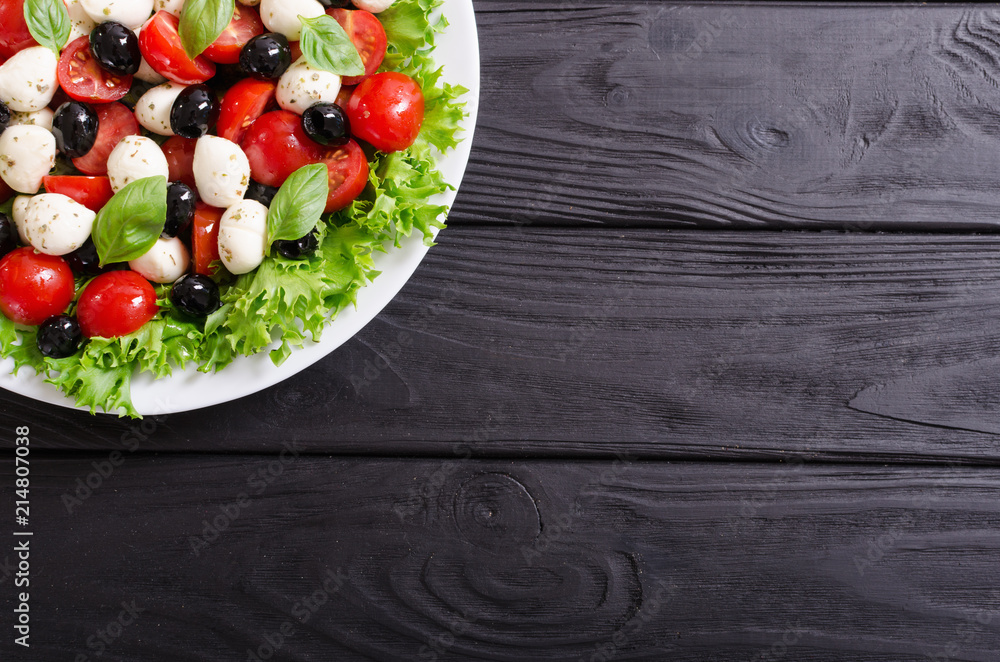 Salad with basil , tomatoes , olives and mozzarella Salad with basil , tomatoes , olives and mozzarella
