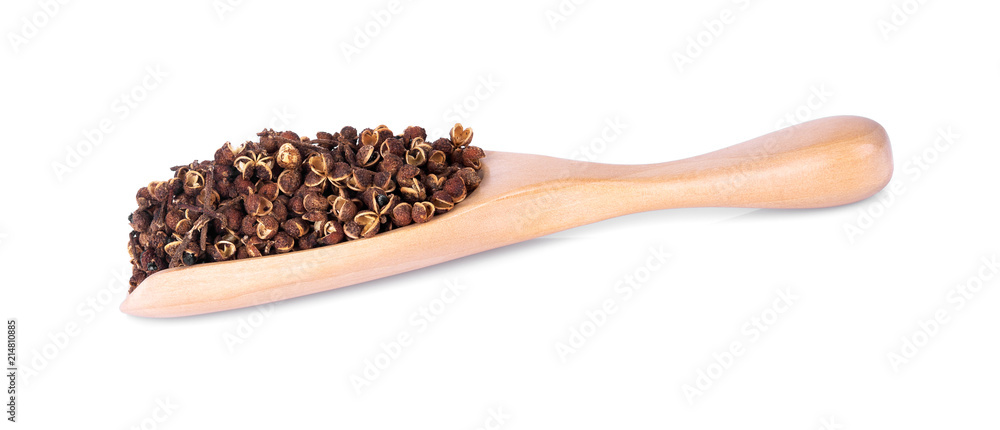 Dry Zanthozylum limonella Alston in wooden spoon on white background. Dry Zanthozylum limonella Alston in wooden spoon on white background.