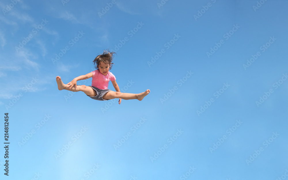 Little girl jumping. Isolated on a blue sky Little girl jumping. Isolated on a blue sky
