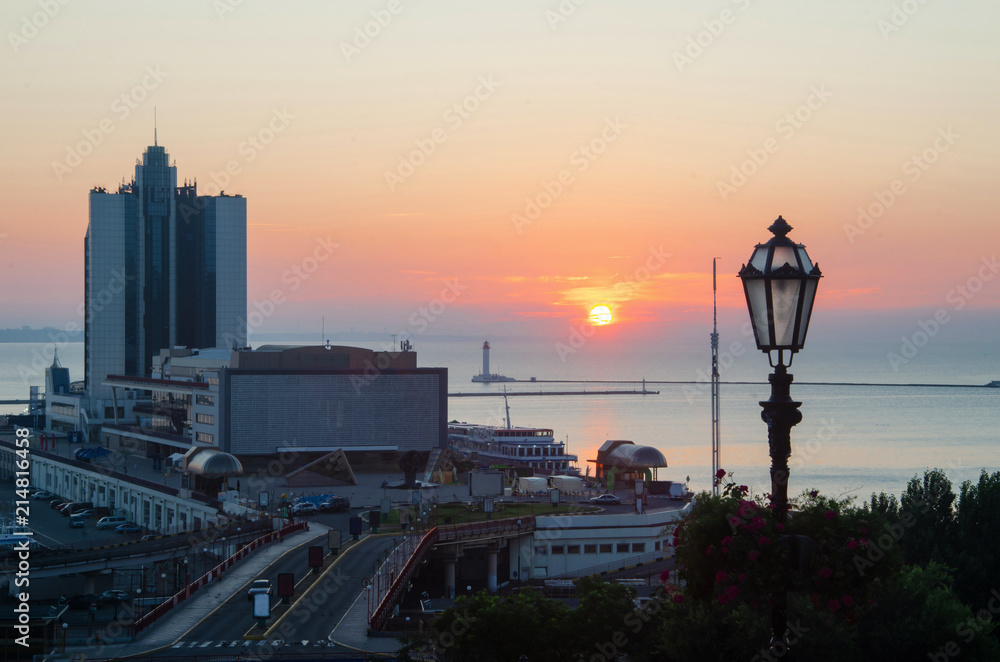 Sunrise against the background of the sea station, the port and the Potemkin Stairs in the city of Odessa, Ukraine.