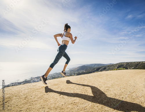 Woman jogging on mountain photo